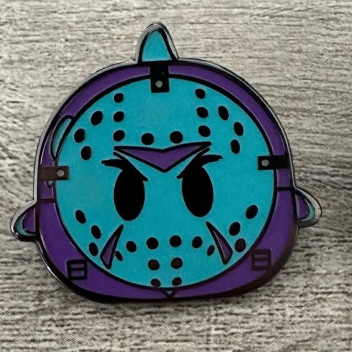 Purple and Aqua Blue ghost with hockey mask on.